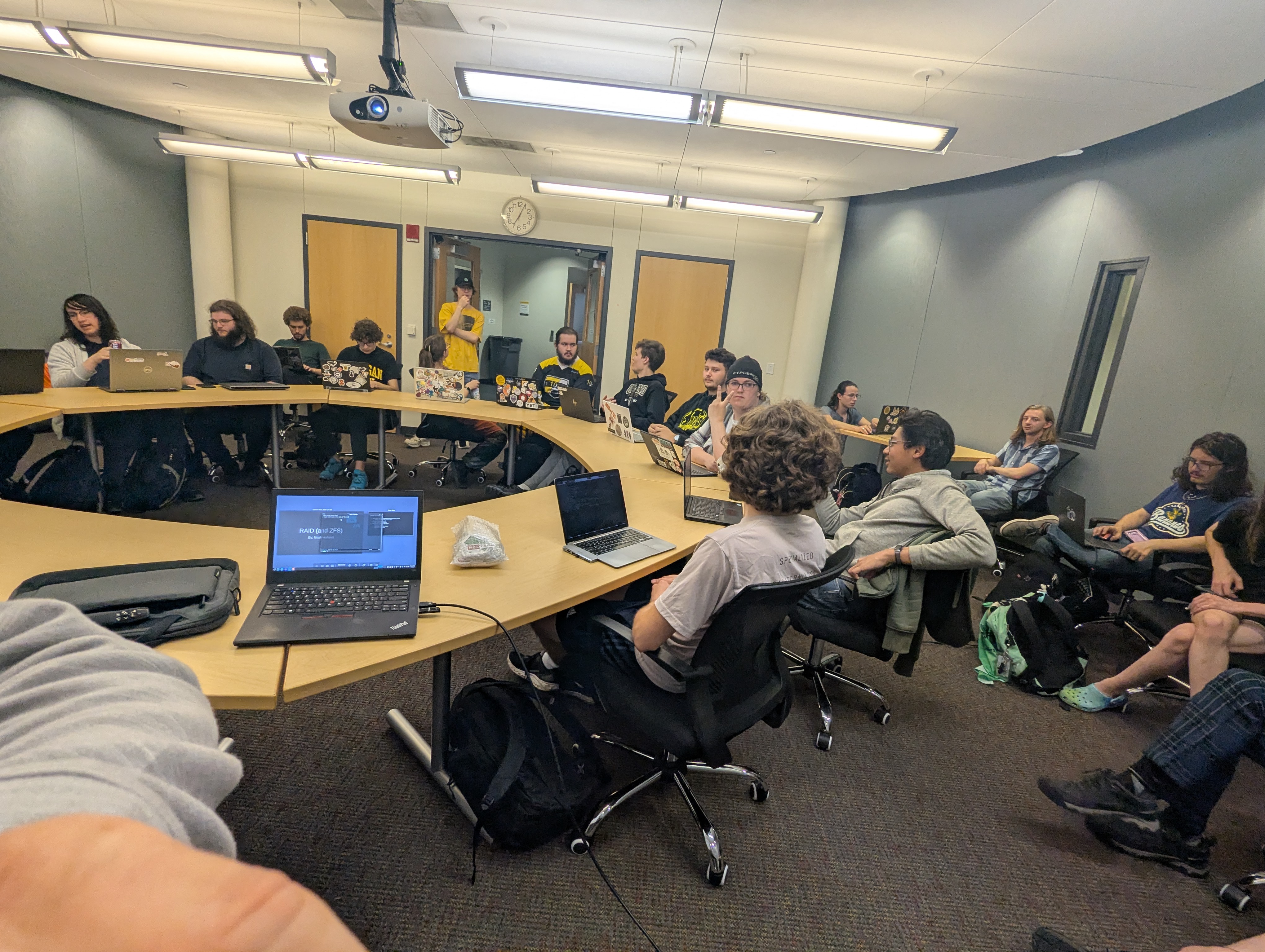 photo of a bunch of nerds sitting in a room to talk about some kind of penguin software